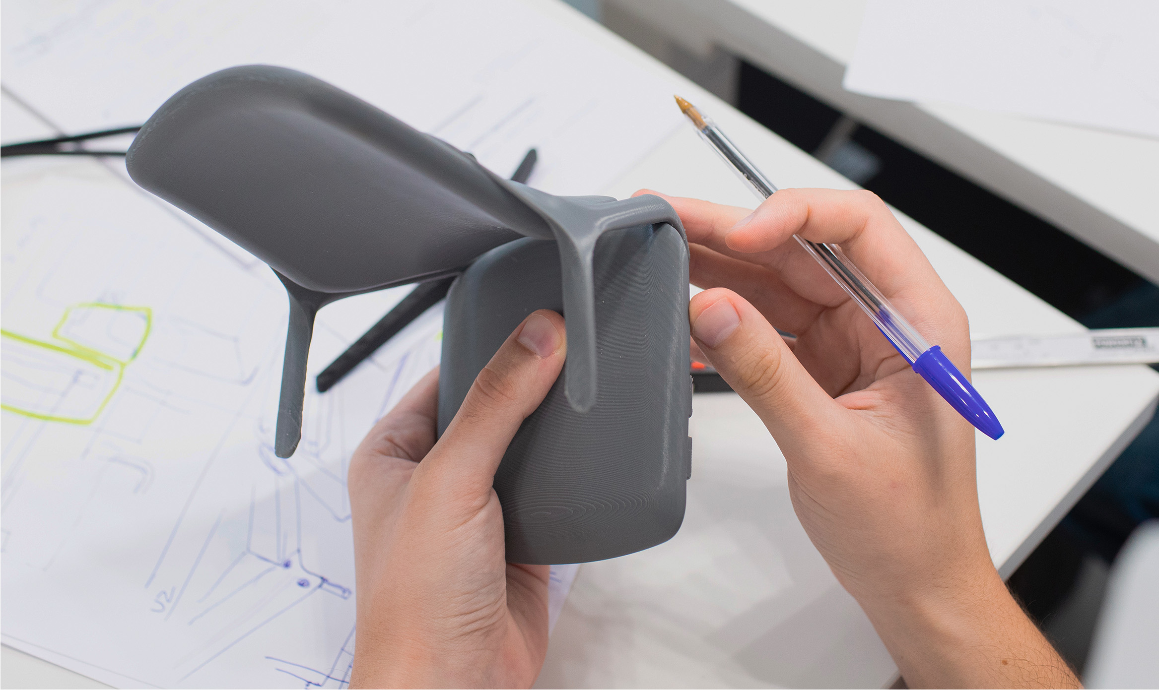 Designers at Alegre Design working on a prototype of the OFY chair for Narbutas. The image showcases the hands-on design process and expertise of Alegre Design in creating ergonomic and innovative office furniture.