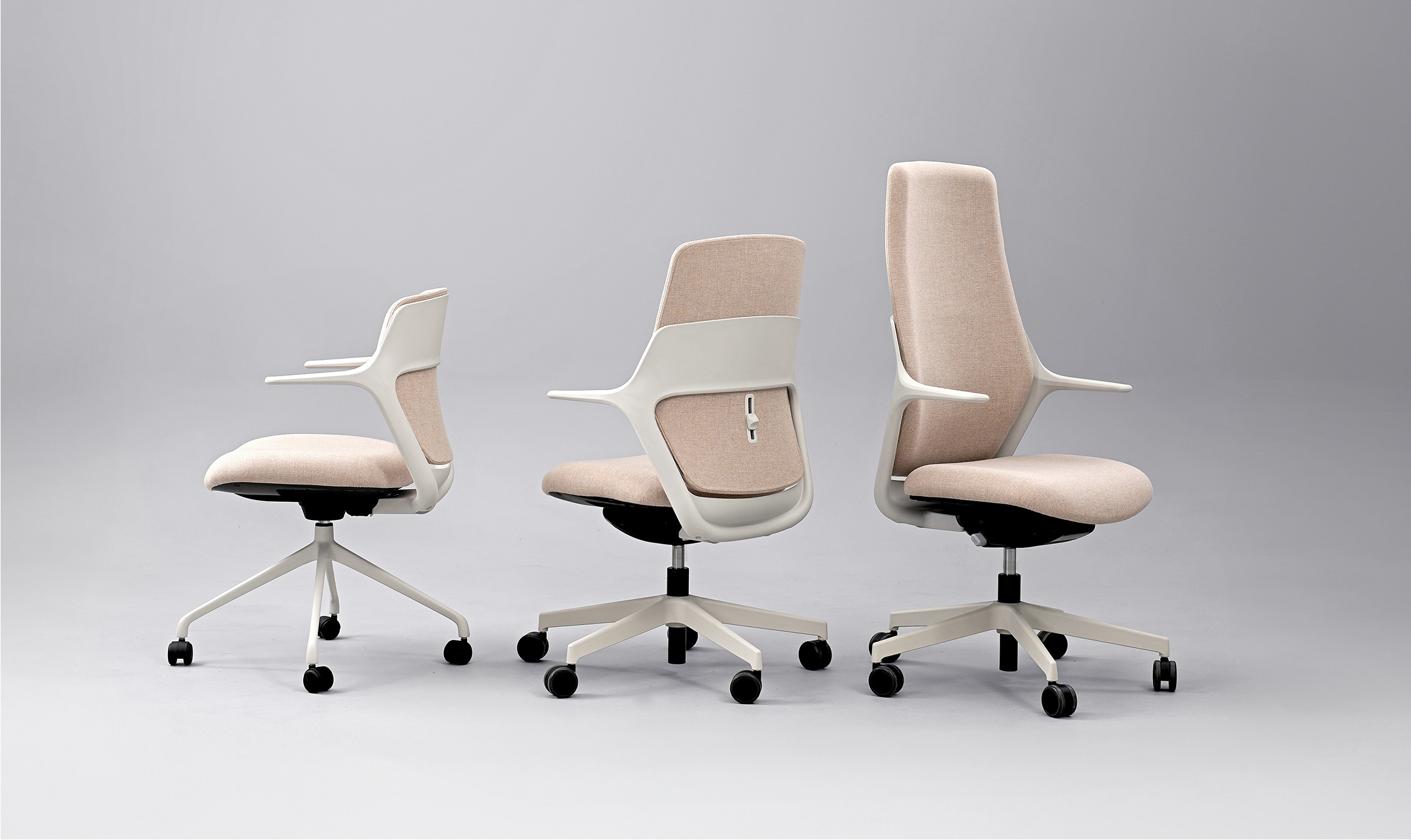 Three OFY chairs designed by Alegre Design for Narbutas, shown from different angles. The chairs feature ergonomic design, beige fabric finishes, and adjustable lumbar support, ideal for modern office settings.
