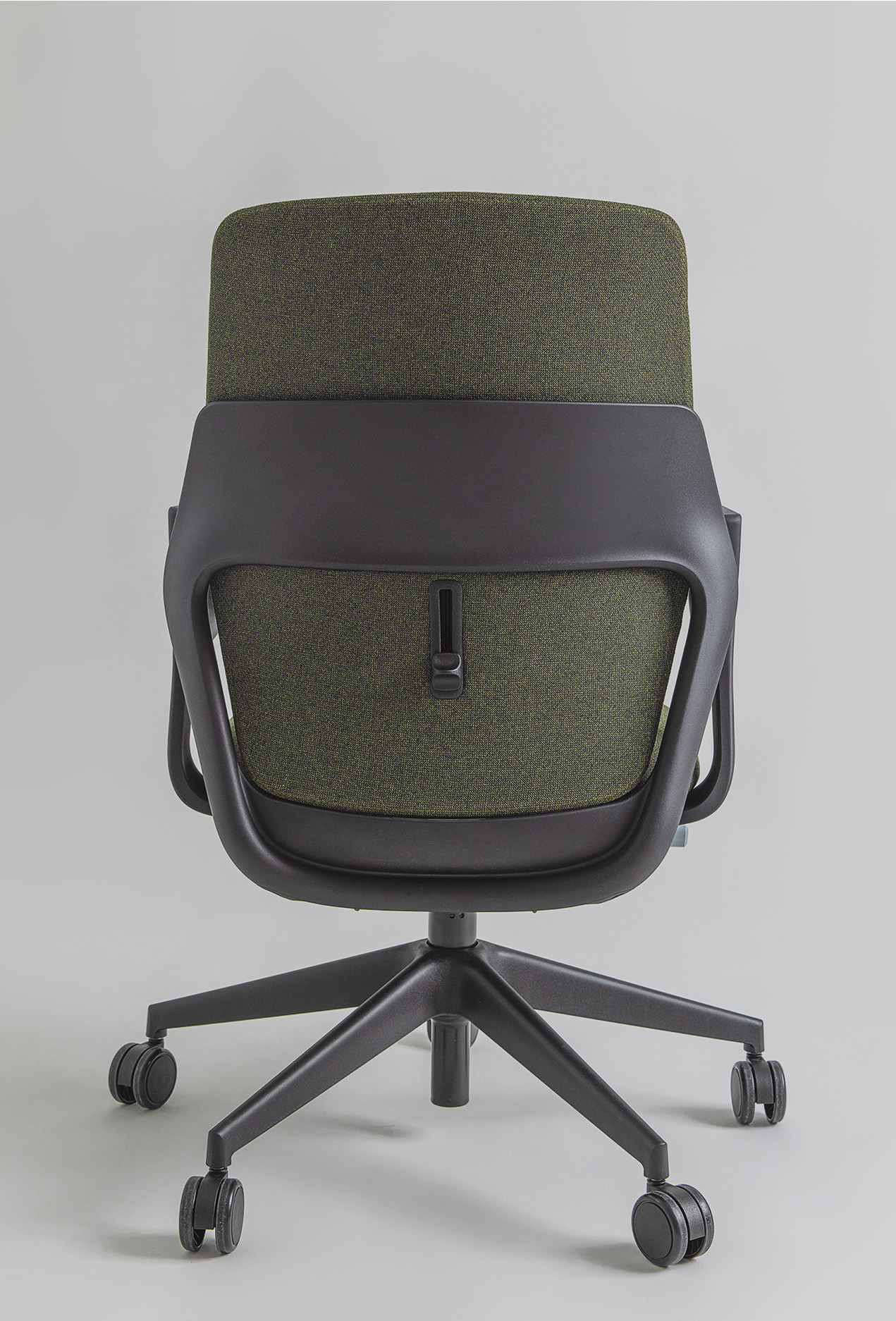 Rear view of the OFY chair in green by Narbutas, designed by Alegre Design. The chair features an ergonomic thermoplastic backrest, customizable finishes, and adjustable lumbar support, perfect for hybrid and modern workspaces.